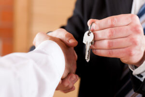 Business Handshake with giving keys