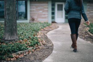 girl walking down sidewalk